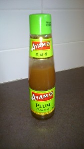 A bottle of "Ayam" plum sauce. The sauce is a light brown colour.